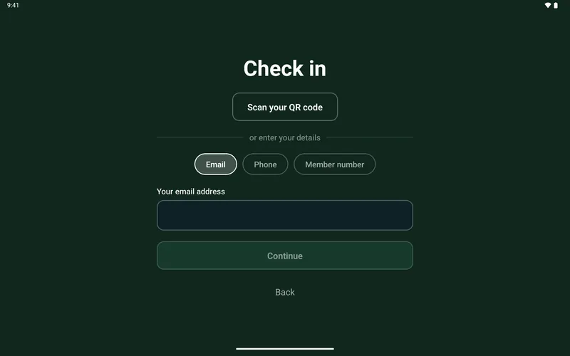 The kiosk asking a guest to scan their booking or type their number